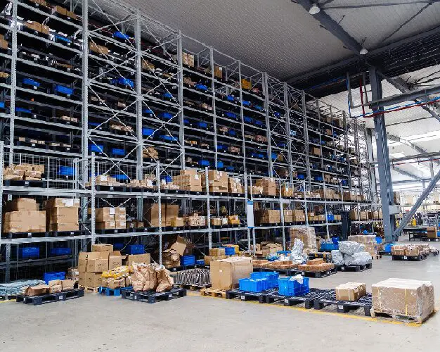 A warehouse filled with lots of boxes and carts.