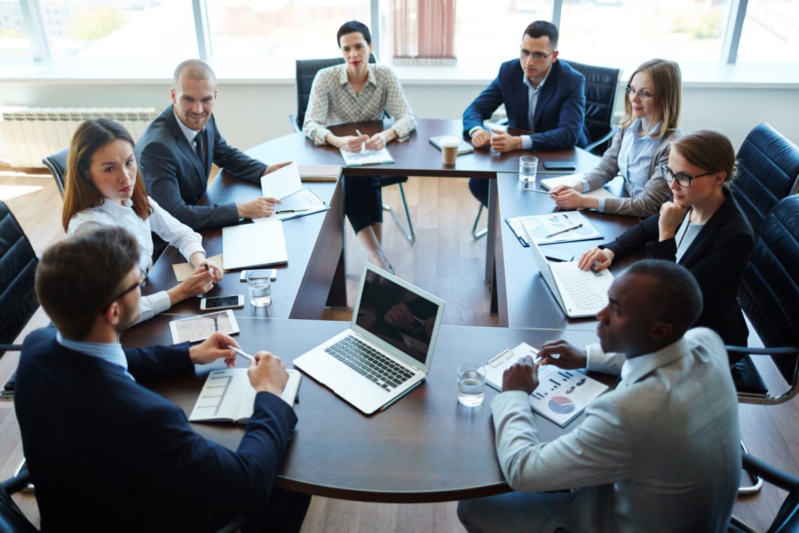 A group of people sitting around a table.