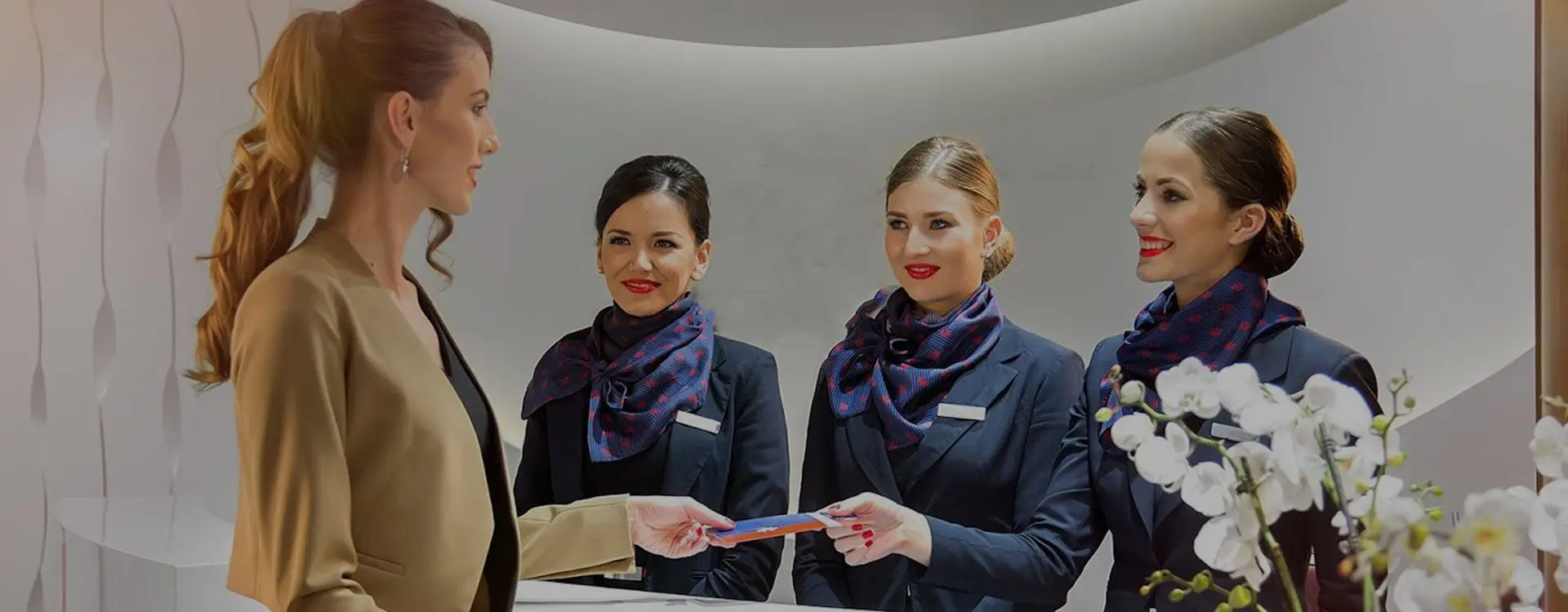 A group of people in business suits holding cards.